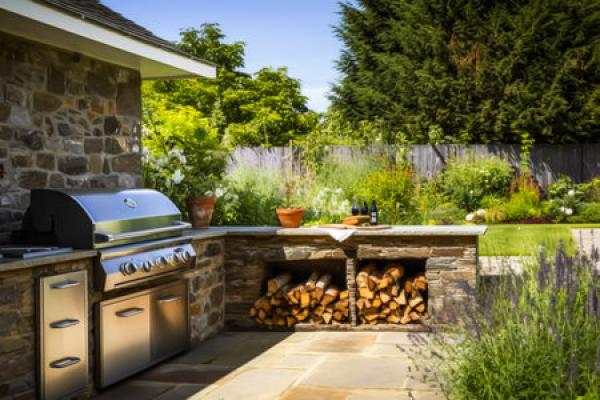 An outdoor kitchen with a grill and a large countertop