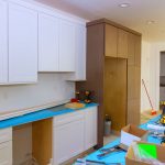 A kitchen being remodeled with equipment out to install new cabinets and countertops