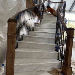 A wrought iron staircase with marble stairs from MC Granite Countertops in Atlanta.