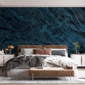 A bedroom with blue and black marble wall panels on one wall.