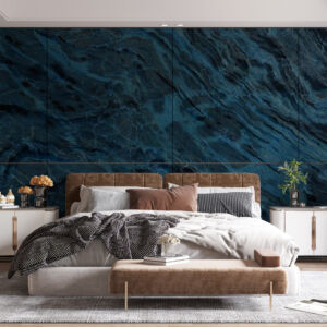 A bedroom with blue and black marble wall panels on one wall.